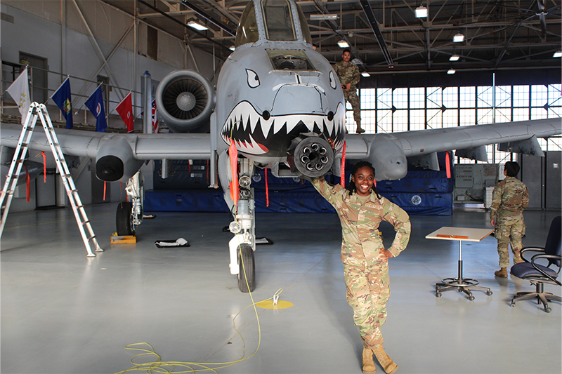 Nadine Hudson ’18 posing in front of a plane.