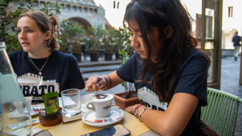 Dora Crespo ’26 enjoys a drink at an outdoor café.