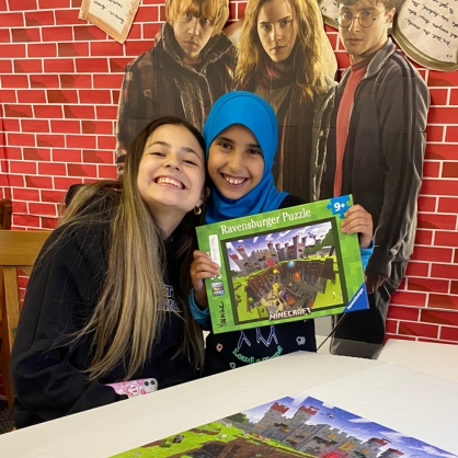 Nora Isabela Garcia Punin ’26 (left) has shared the joy of reading – and puzzles – with kids as part of her work with New Haven Reads.