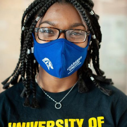 Student smiling behind a mask