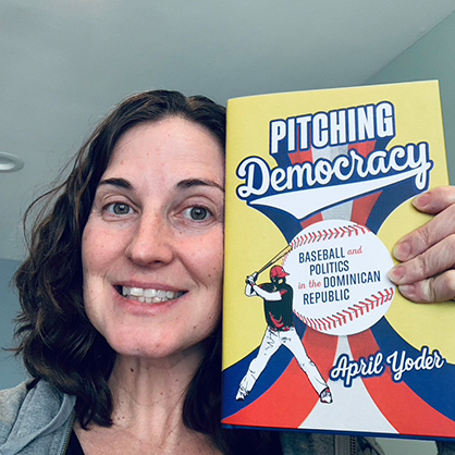 April Yoder, Ph.D., with a copy of her book.