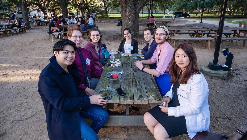 Hang Su ’23 (right) with doctoral students and theoretical physics speakers at the Gulf Coast Undergraduate Research Symposium presenter dinner at Rice University.
