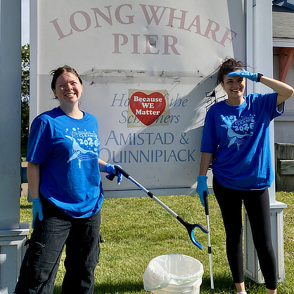 Volunteers in front of Long Wharf sign