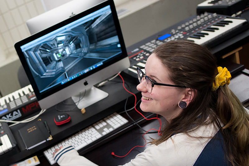 An image of a student using a music program on the computer.