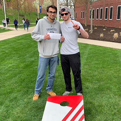 Adam Comuniello ’20, ’22 MBA (left) and Evan Carbognin ’20 won a cornhole tournament at the University that was part of a sport event capstone project.