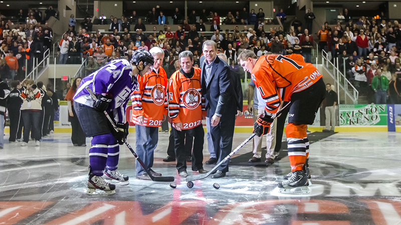 Ben Robert ’81, ’83 MBA (second from right) at an official puck drop in Omaha