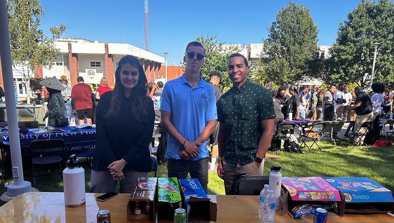 Jalak Popat ’24 M.S. at the University’s Involvement Fair (left) with Christopher O'Connor ’24 and Christian Rosario ’24.
