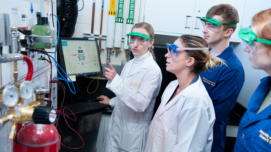 Chemical engineering students in lab with professor