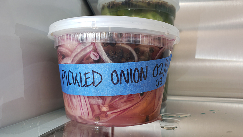 A container of pickled onions.