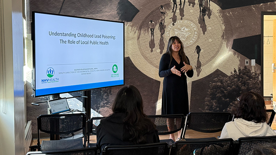 Glenda Buenaventura, deputy director of environmental health, speaks to MPH students about local lead prevention efforts