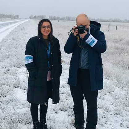 Olena Lennon, Ph.D., posing for a photo in a snowy field with a colleague.