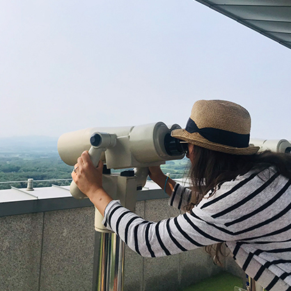 Olena Lennon looking at North Korea through binoculars at the Dora Observatory