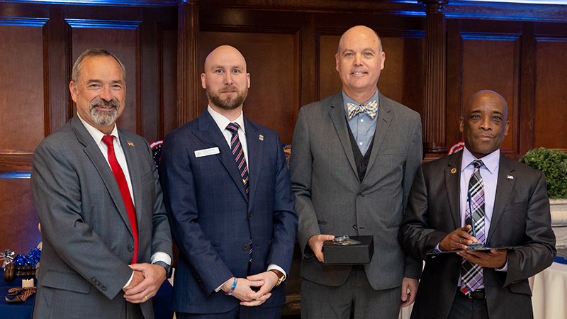 Dr. David Schroeder (second from right) accepted the faculty award on behalf of the Lee College.