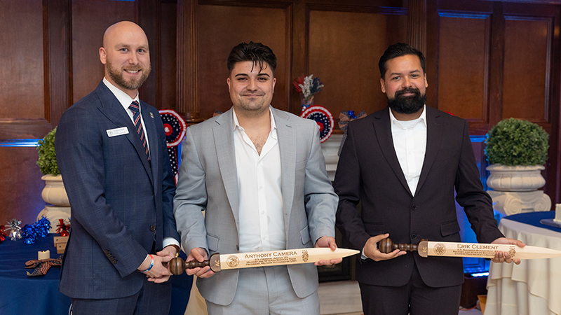 Ryan Noonan '20, '23 M.S. (left) presented Rudis swords to Anthony Camera ’23 (center) and Erik Clement ’23.