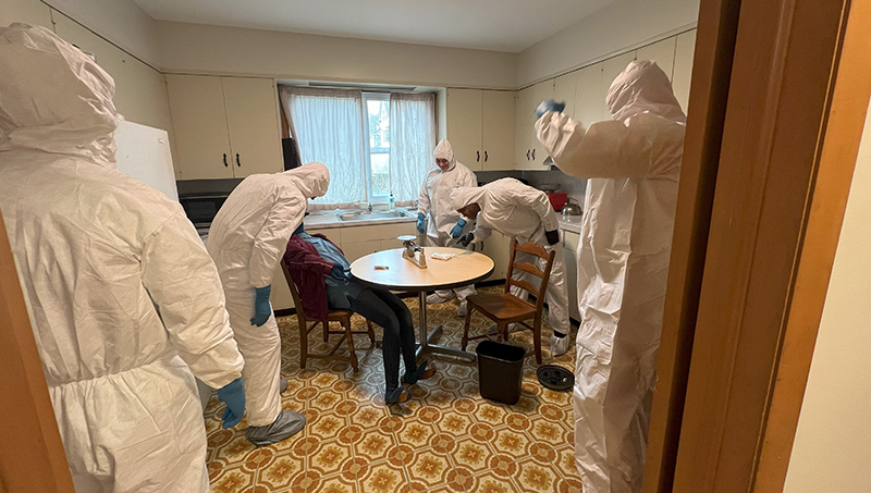 Recruits investigate a mock crime scene at the University of New Haven.