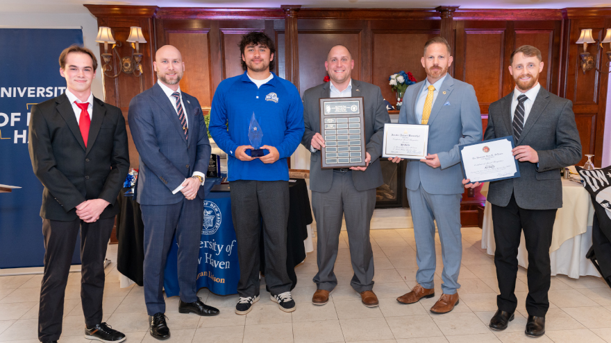 Quarterback AJ Duffy ’28 and head football coach Mark Powell, with the 2nd Annual Military Appreciation Game MVP Award