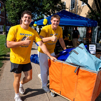 Athletes helping families move in