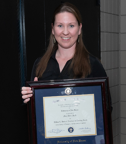 Dr. Mary Isbell holding award