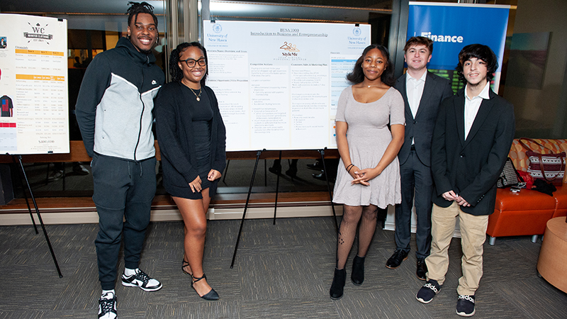 Students with their poster for “StyleMe,” a virtual personal shopper. 