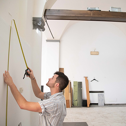 Zachary Ferrauolo ’23 takes measurements at the tenant space.