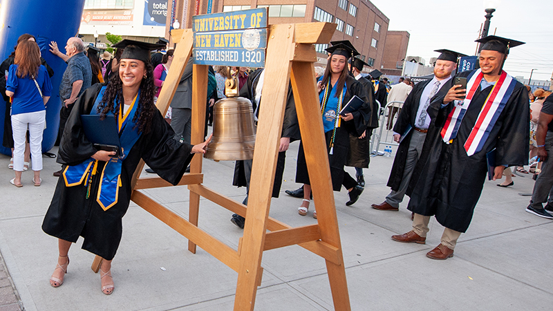 Gabriela Garcia-Perez ’23, ’24 M.S. rings the Alumni Bell after the ceremony
