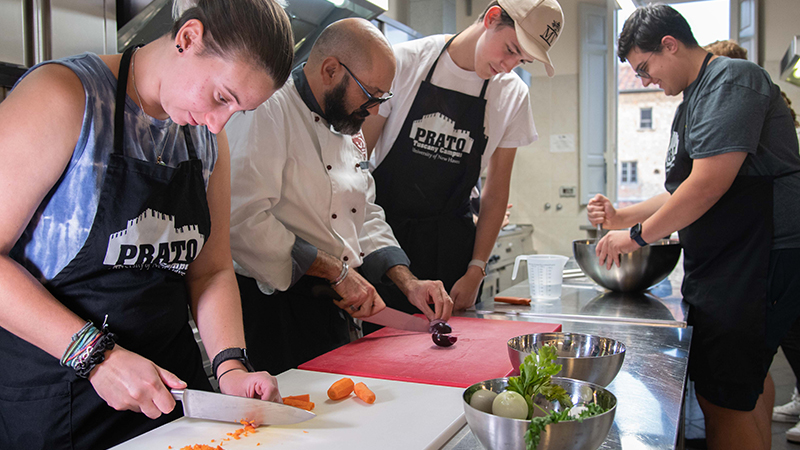 A local chef teaches students how to prep a meal.