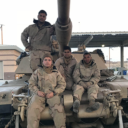 Andrew Ghataora '24 (front) with his fellow crewmembers after his first training exercise as a tank commander. 