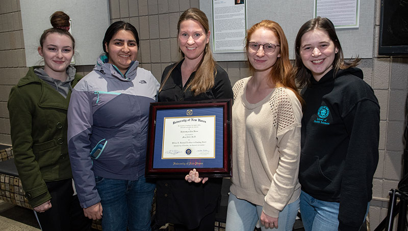 Photo of Mary Isbell, Ph.D. and her students. 
