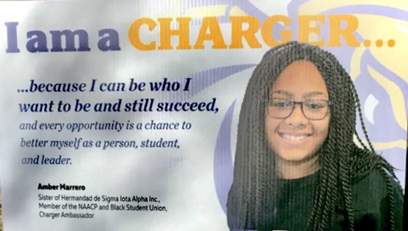 Amber Marrero's picture on University lawn sign. 