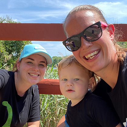 Carrie Robinson, posing with her wife Justine, and their son Logan.