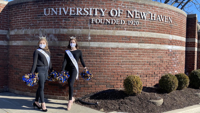 Ashlyn Mercier ’23, ’24 M.S. and April Mauceri ’24, ’25 M.S. in front of the UNH sign.