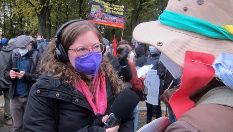 Image of Sylvia Cunningham reporting on a climate strike.