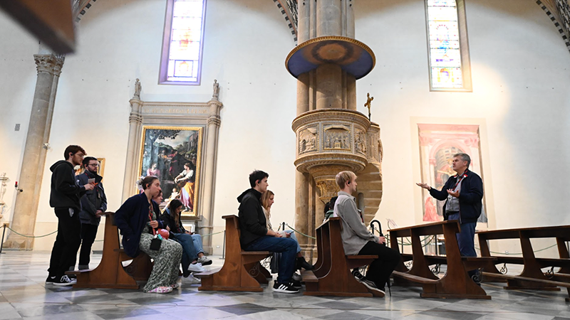 Kevin Murphy, Ph.D., and students near the pulpit where the astronomer Galileo Galilei was first publicly denounced.