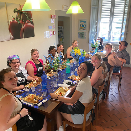 Students share a meal together in Italy.