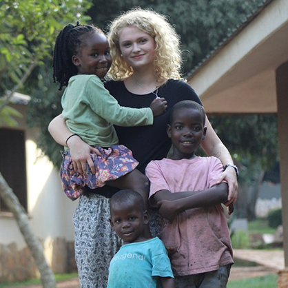 Image of Laney Phillips with children from her most recent trip to Uganda.