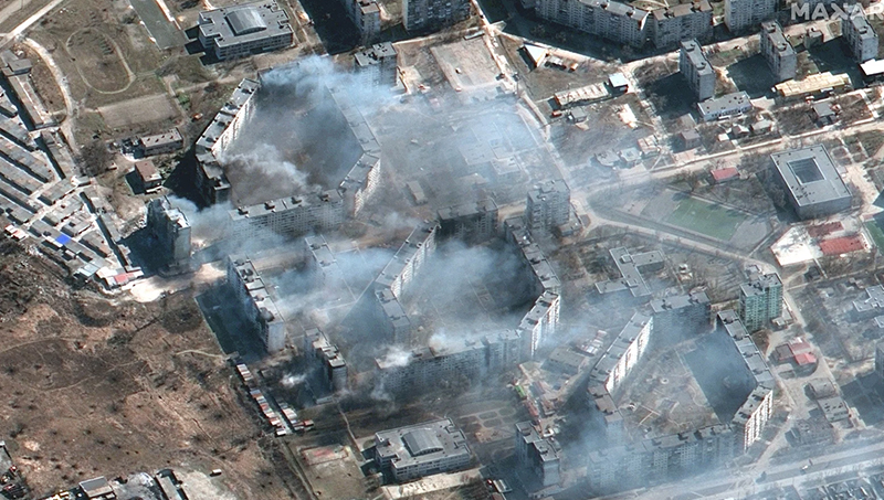 Maxar satellite imagery showing burning apartment buildings in northeastern Mariupol, Ukraine.