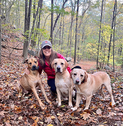 Lynne Resnick hiking with her dogs Scooby (left), Archie (center), and Jack in Prospect, CT.