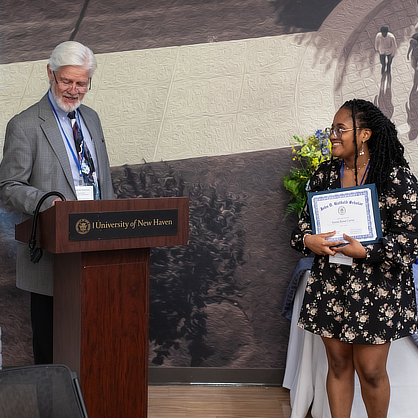 Syrena Carver ’24 accepts her award as part of the luncheon.