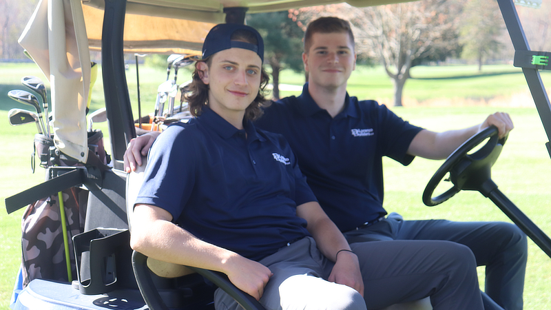 Remo Dilorenzo ’25 (left) and Thomas Portnoy ’25 at the golf outing. 