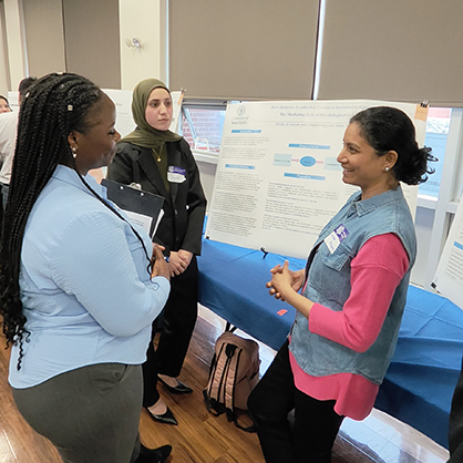 Amina Almoustafa ’24 M.S. (center) and Indra Ponnuswamy ’24 M.S. (right) discussed their work with their fellow Chargers.