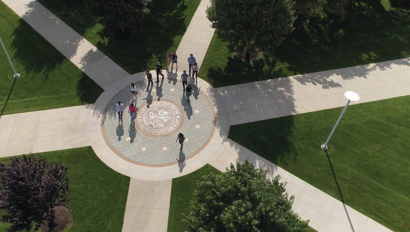 Photo of University of New Haven seal in the center of the Maxcy Quad.