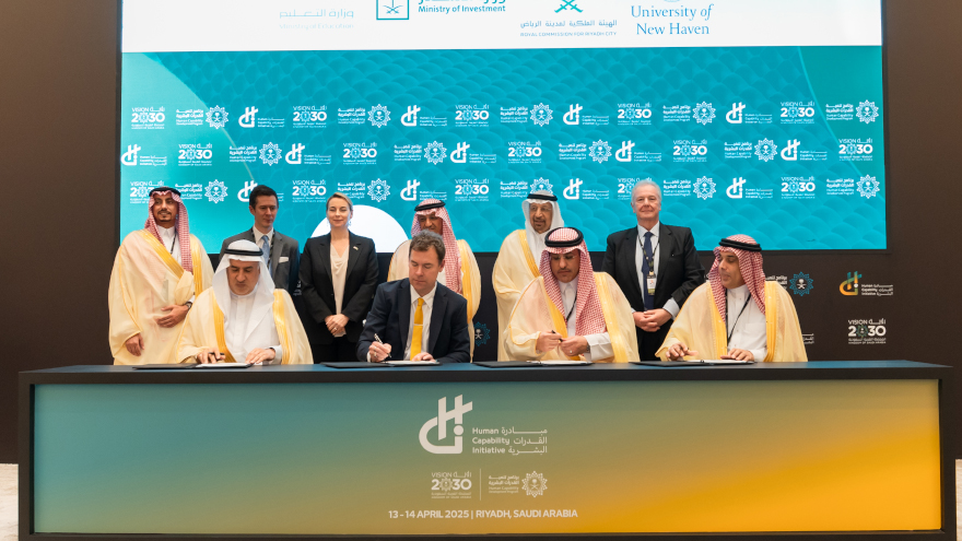 group of leaders at table signing documents