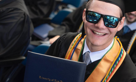 A graduation cap, tassle, and diploma case.