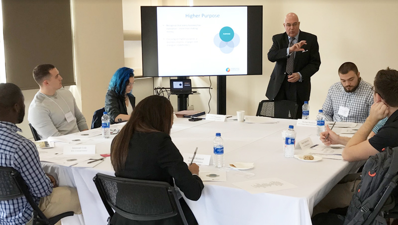 Image of Larry Bingaman ’96 EMBA discussing his ‘conscious capitalism’ philosophy with students.