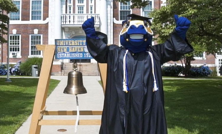 Image of Charlie ringing the alumni bell
