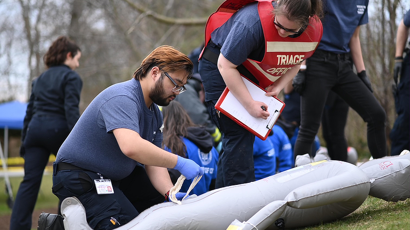 Students 'treat' victims while responding to a mock disaster.