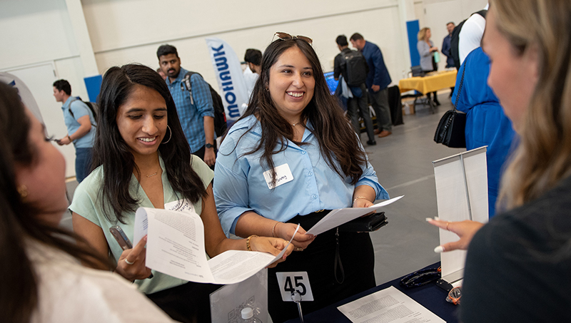 Anchal Bhatia ’24 MBA (left) and her fellow Chargers networked at the University’s recent Career Expo. 