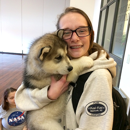 Kaelea Caporuscio '20 cuddles a Malamute puppy.