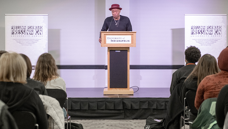 Randall Horton, at a podium, reading from his work.