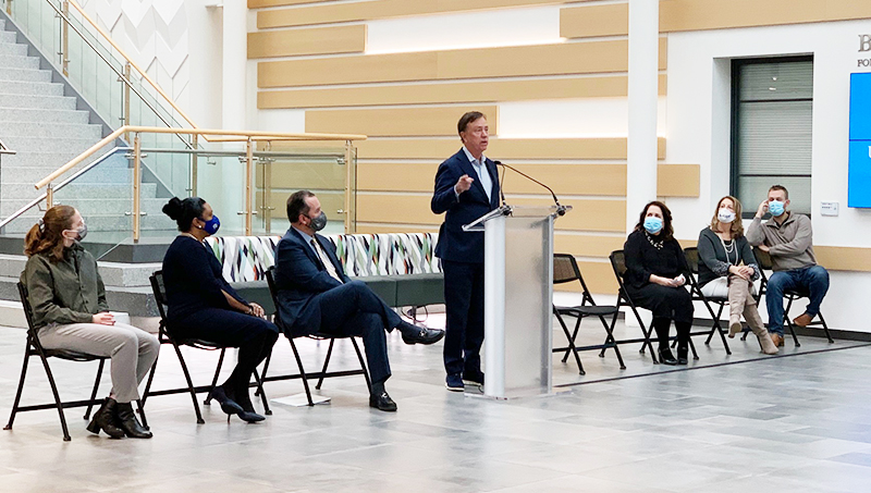 Governor Ned Lamont speaks at a podium at a mental health event.